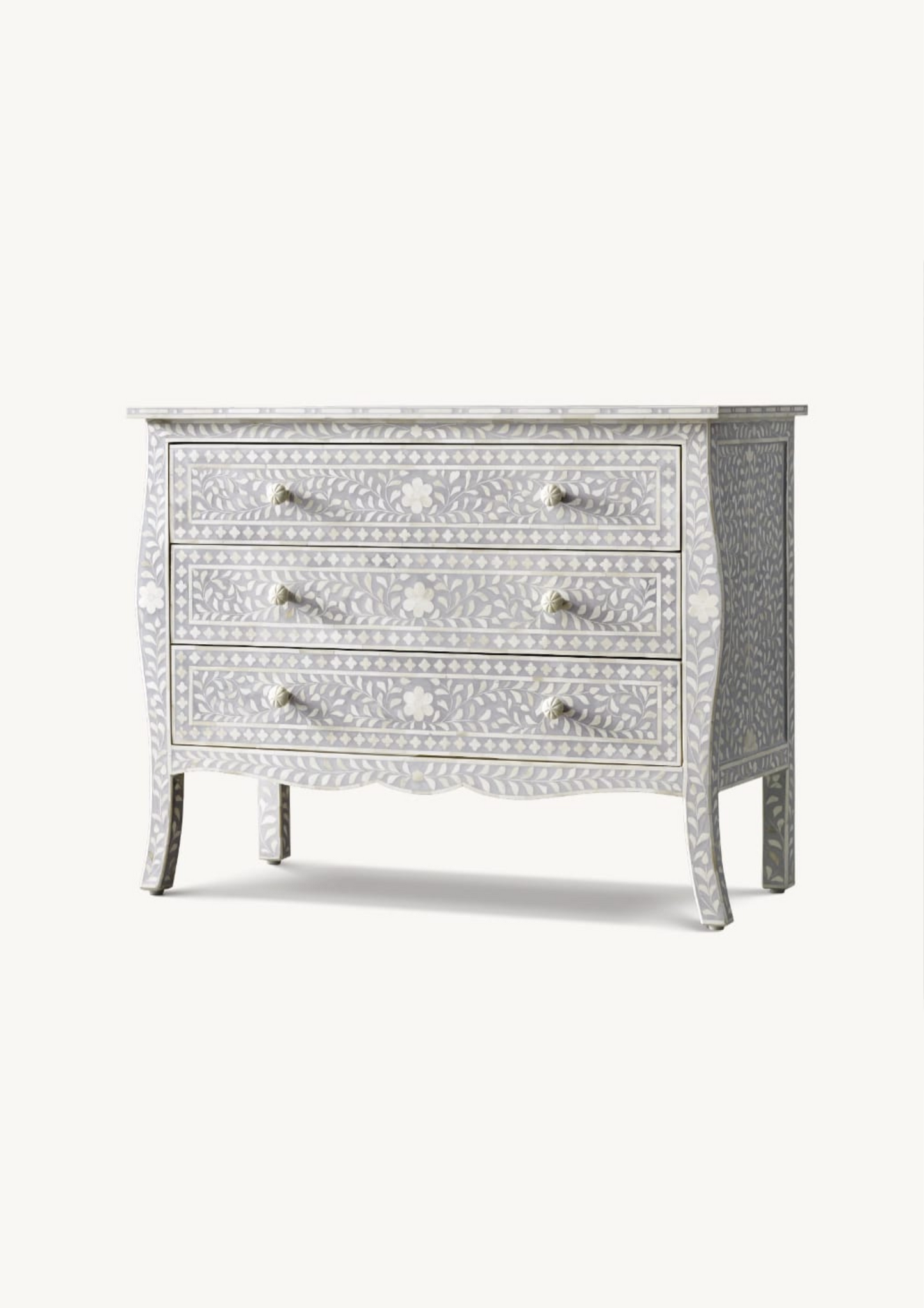 Decorative chest of drawers with intricate inlay patterns on a white background