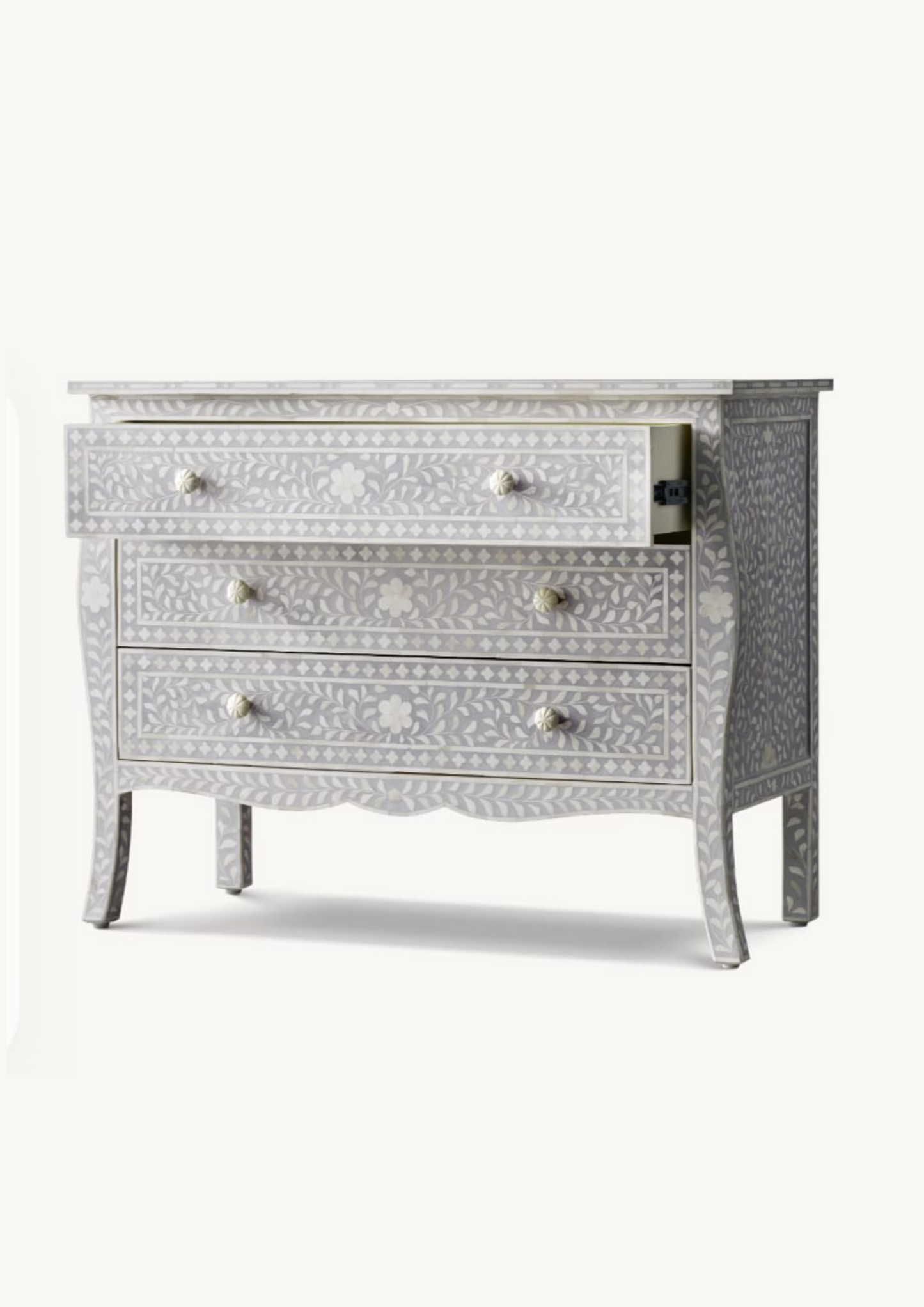 Decorative chest of drawers with intricate bone inlay patterns on a white background