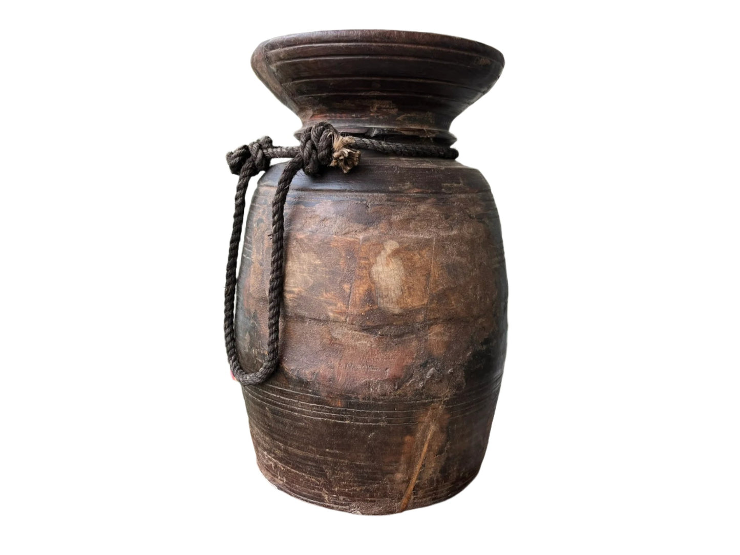 A vintage Himalayan pot made of old wood with a rustic finish, featuring a handle and a rope detail.