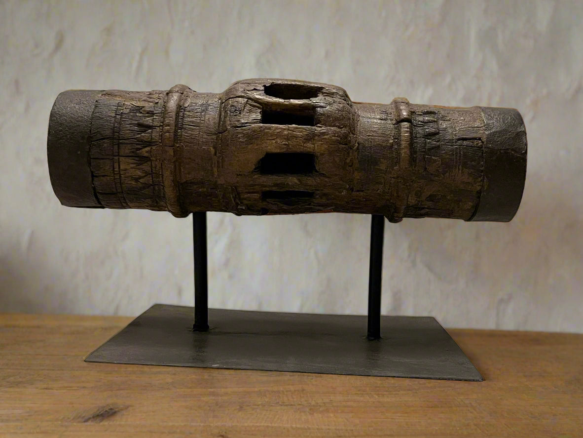 Vintage wooden carriage wheel hub from ancient India, repurposed into collectible decor with weathered, hand-carved details, showcasing sustainable craftsmanship by The Artisans Vault