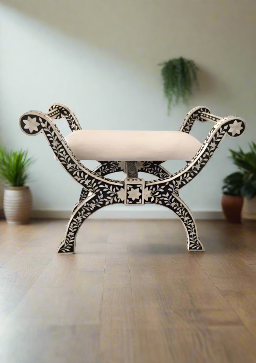 Bone inlay stool with intricate design and white cushion on a white background