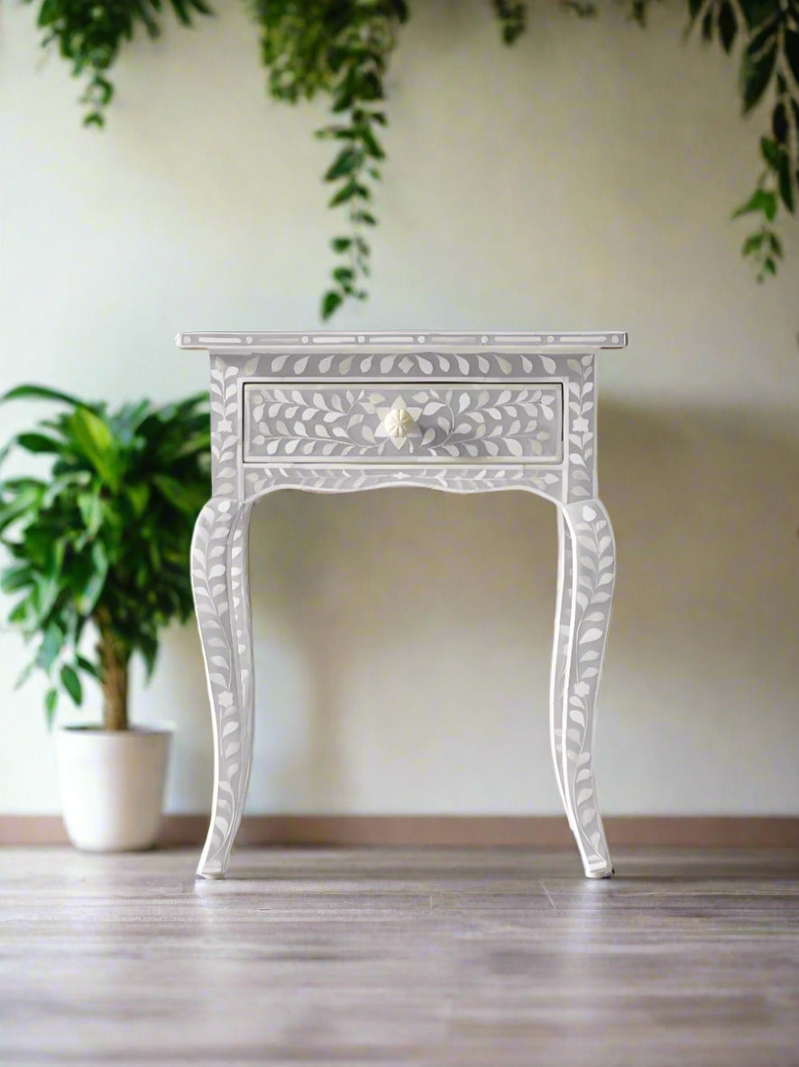 Decorative inlay side table with intricate patterns on a white background with curved legs