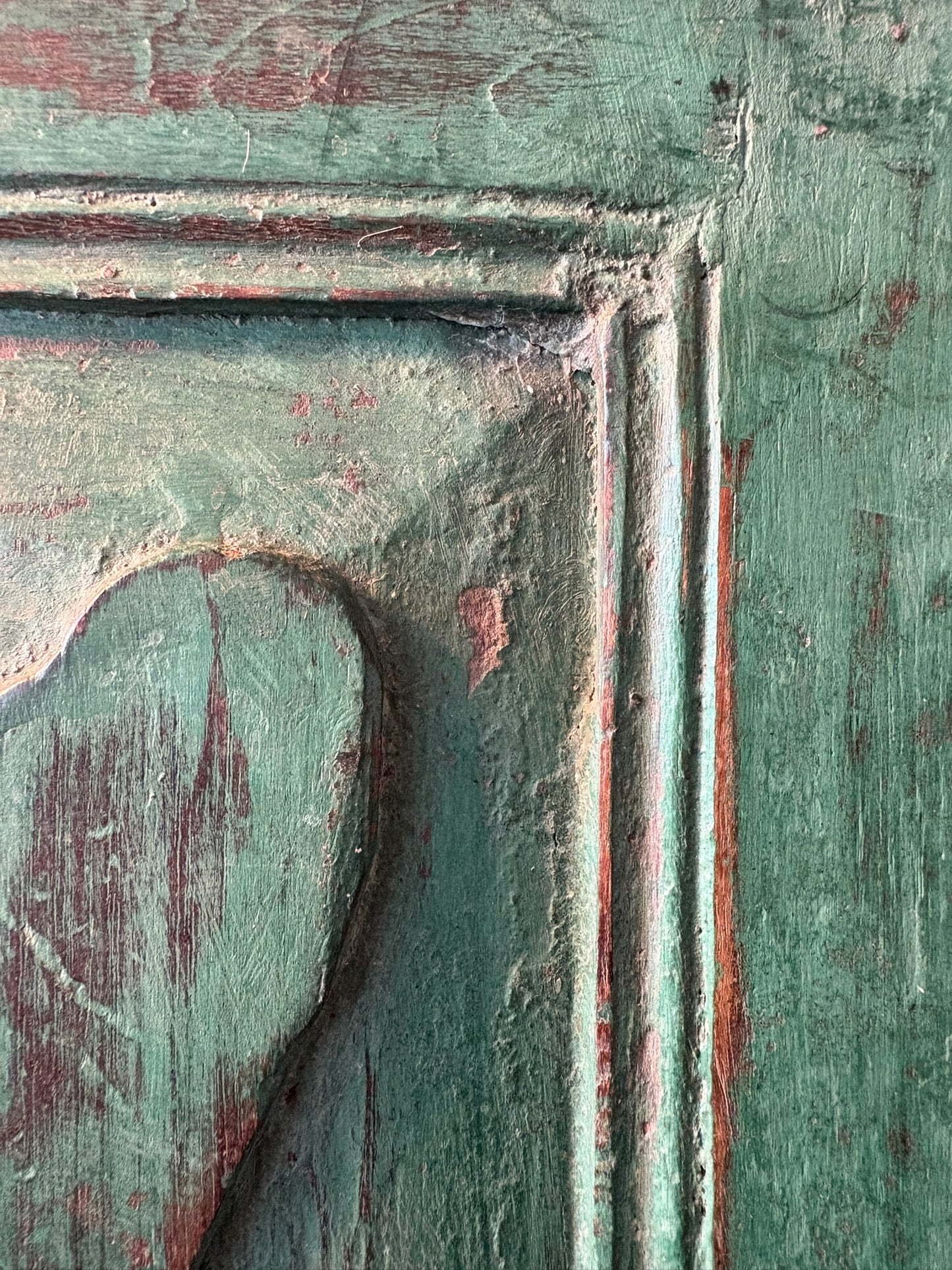 Close-up of an old wooden mirror frame with aged patina