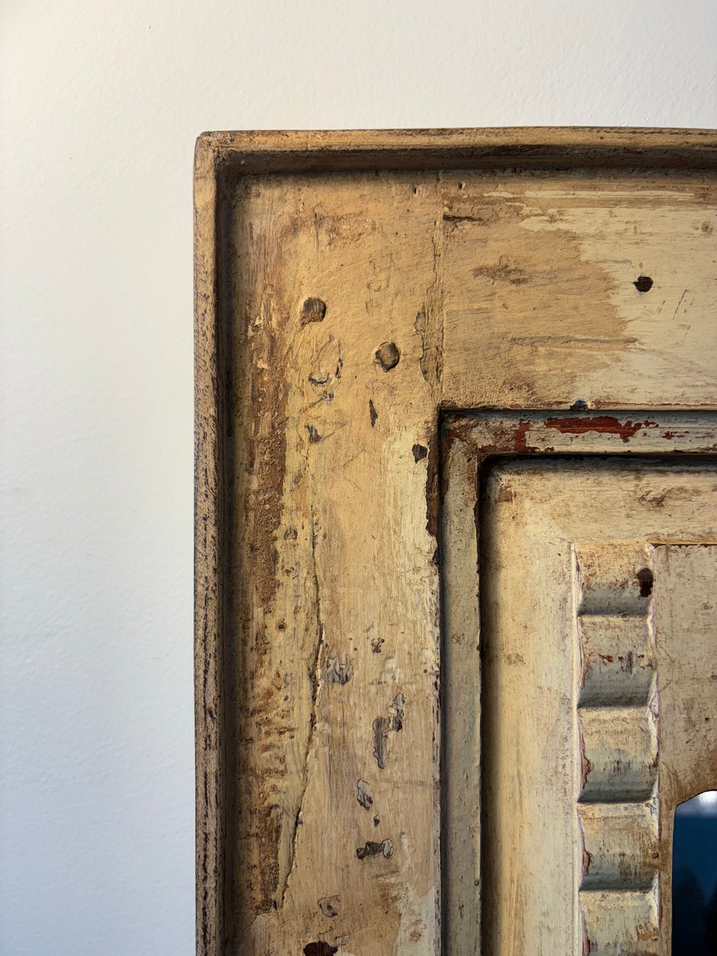 Close-up of a rustic wooden frame with visible wear and tear on a white background