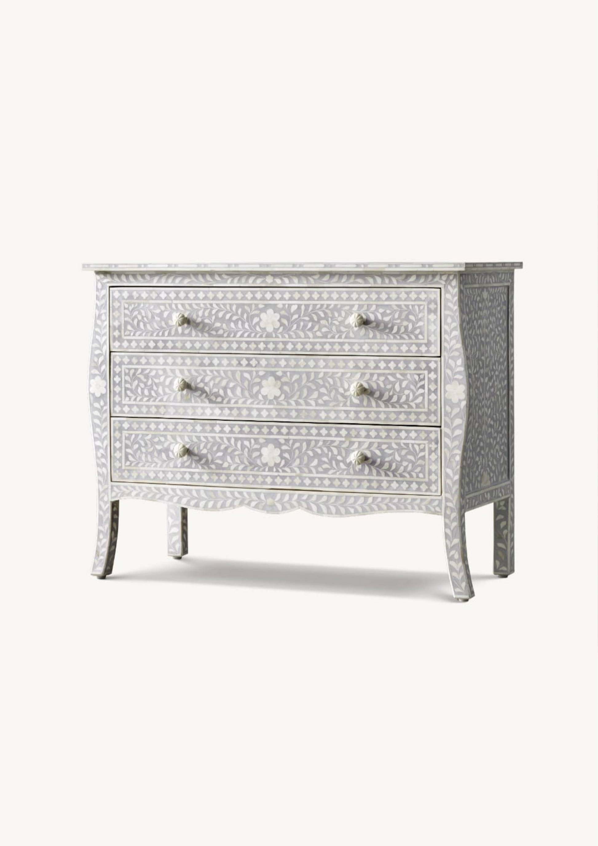 Decorative chest of drawers with intricate inlay patterns on a white background