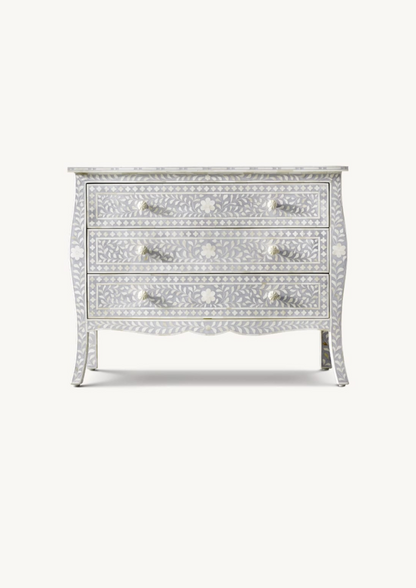 Decorative chest of drawers with bone inlay on a white background