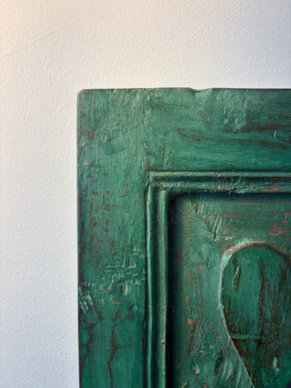 Close-up of a textured green mirror surface with a white background