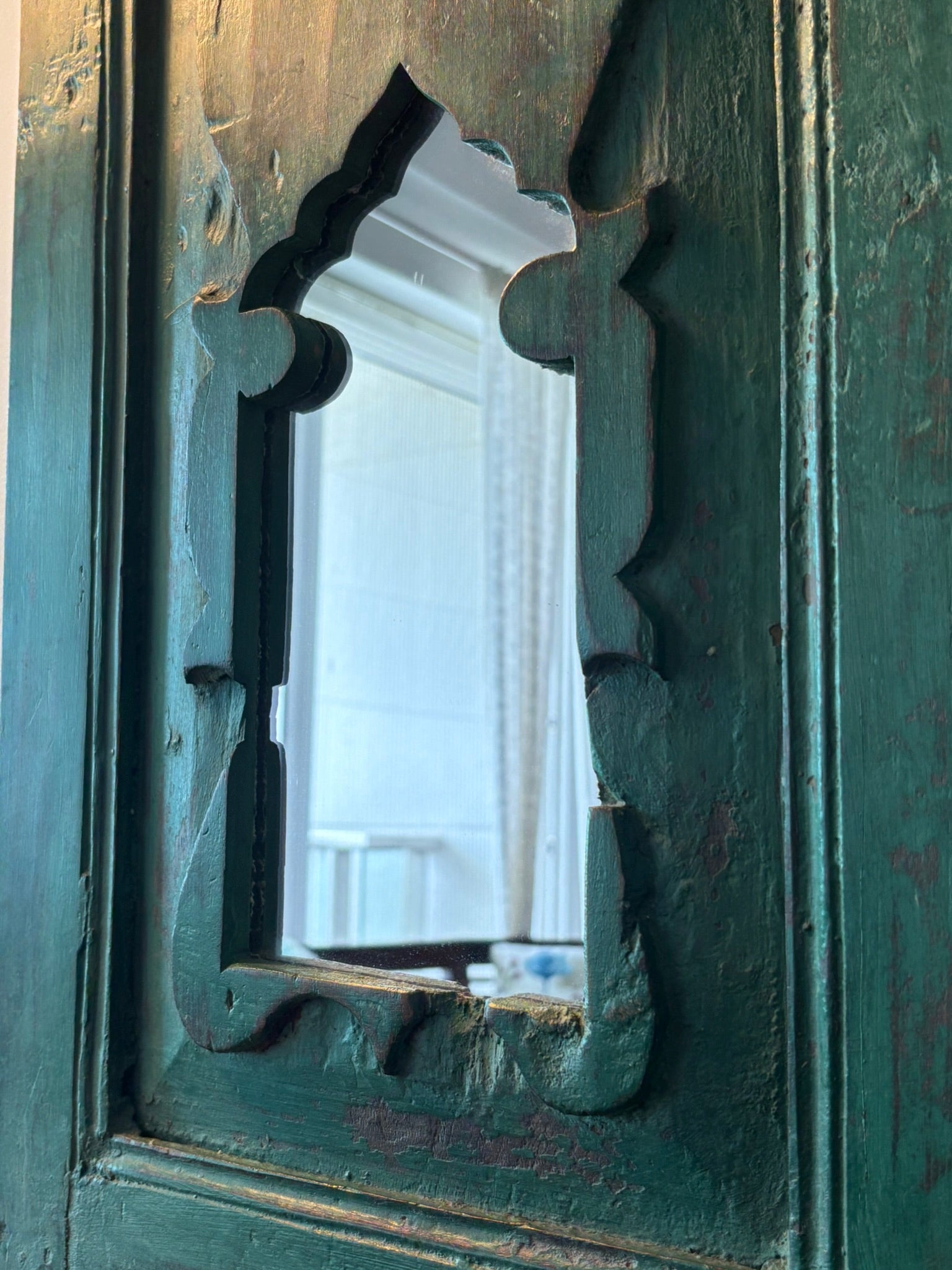 Vintage mirror embedded in a wooden frame with aged patina