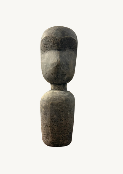 A hand sculpted terracotta statue with an abstract design, depicting a figure standing upright.