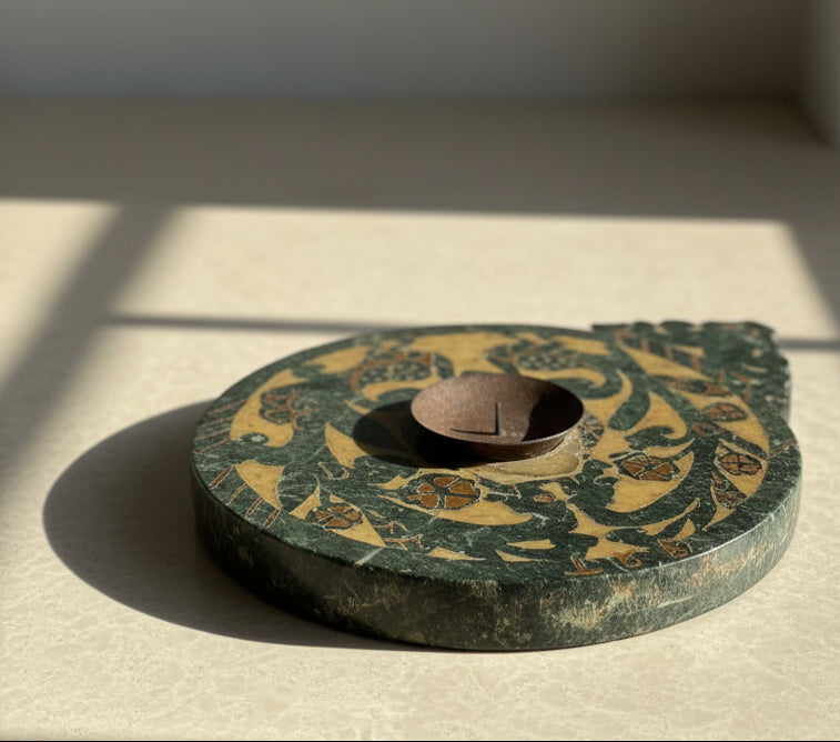 Decorative stone decor object with intricate patterns on a light surface