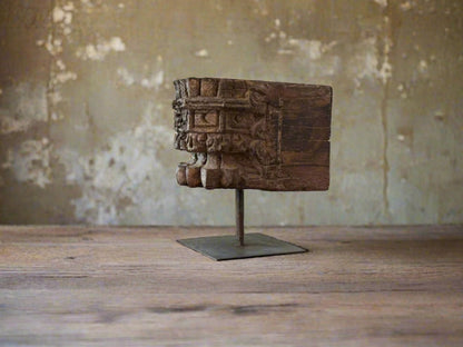 antique pillar candle holder against a neutral background