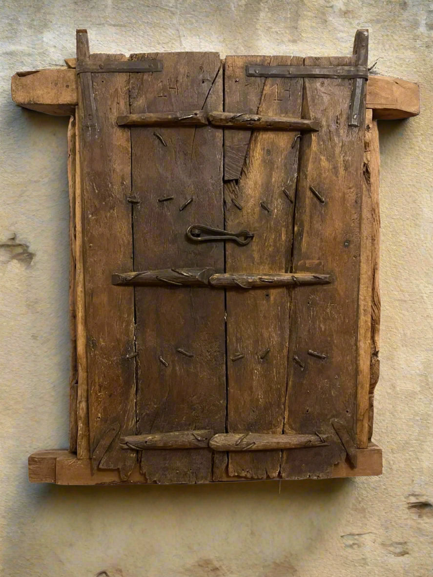 Vintage wooden door with a handle on a textured wall