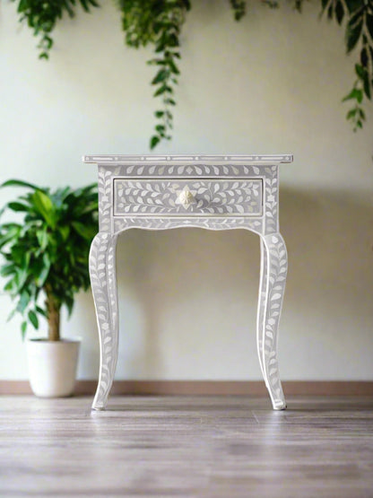 Decorative inlay side table with intricate patterns on a white background with curved legs