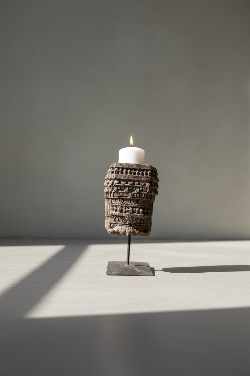 hand carved antique candle stand from India against a background
