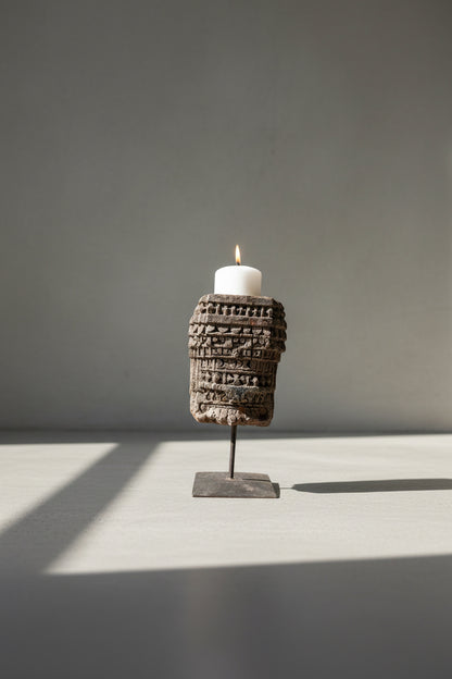 hand carved antique candle stand from India against a background
