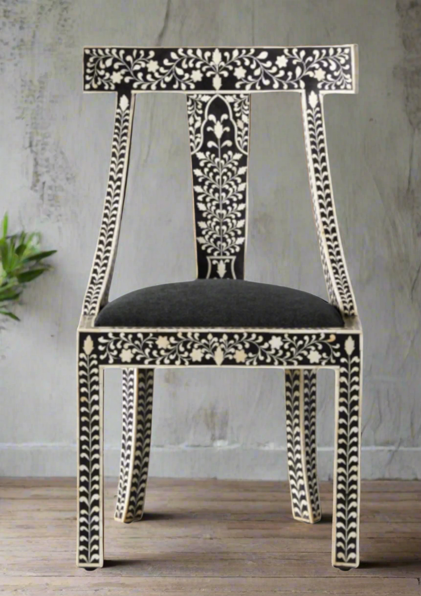 Decorative inlay chair with intricate black and white patterns on a wooden floor.