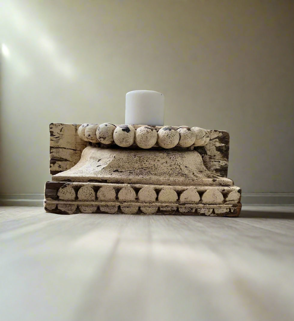 Part of an antique Indian pillar made into a candle stand with an aged patina